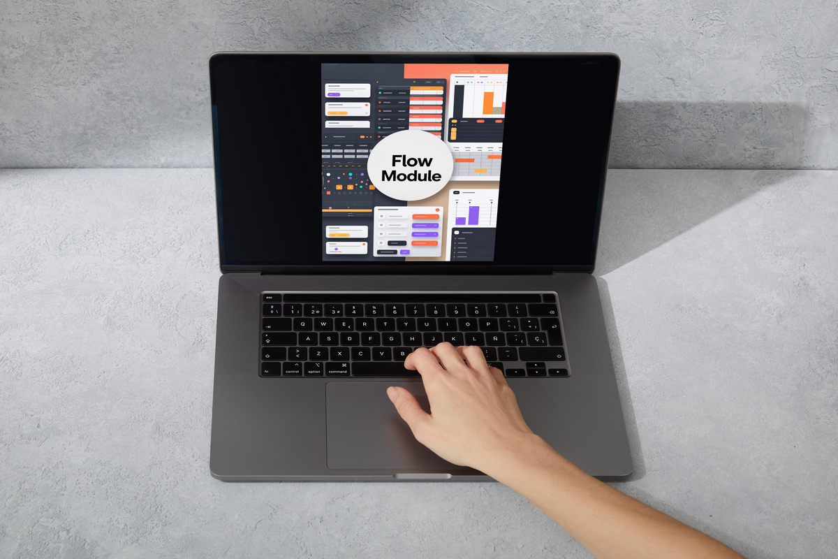 A gray laptop on a light gray textured surface, with a hand resting on the trackpad. The screen displays a software interface labeled 'Flow Module'.