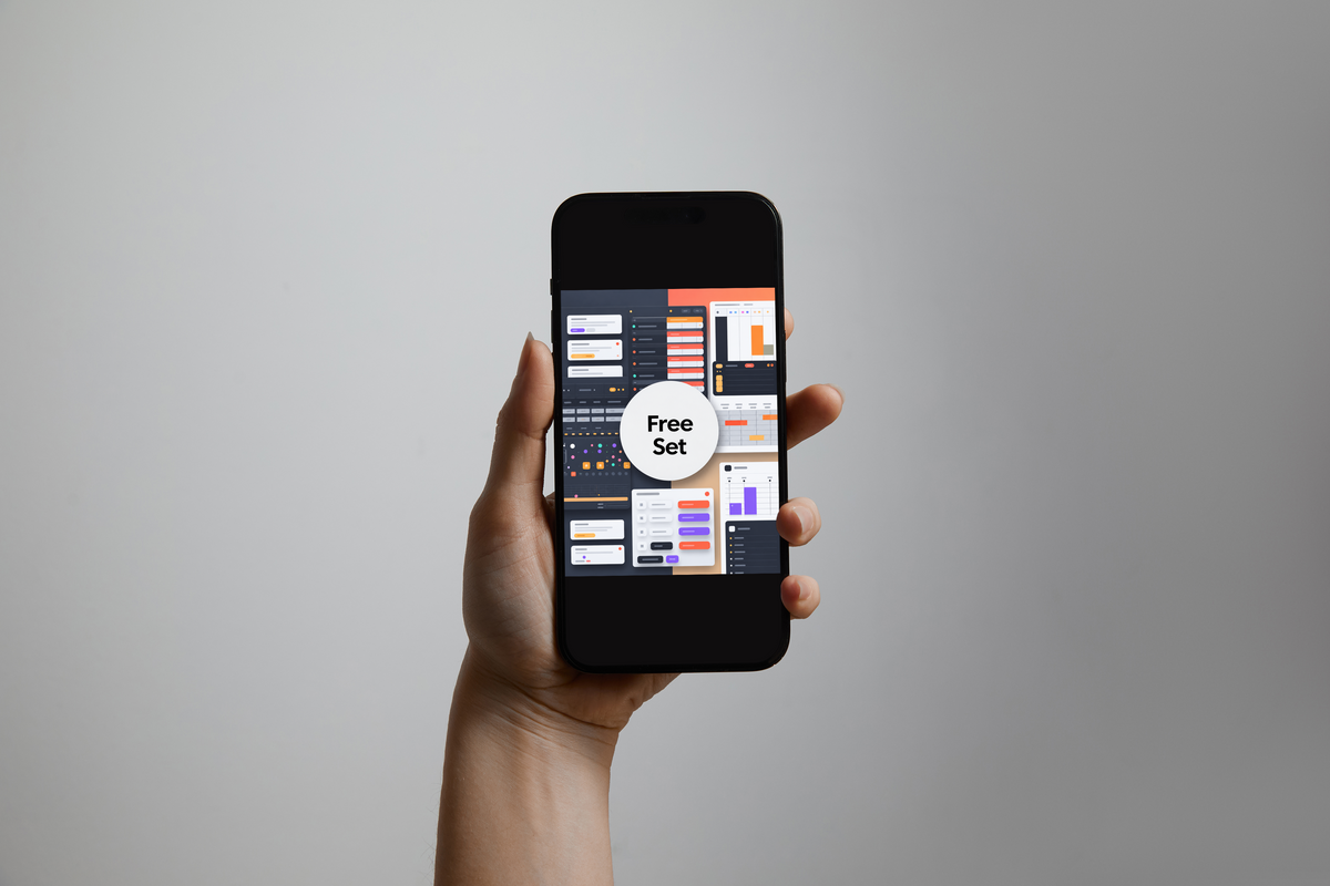 A hand holding a black smartphone against a plain gray background, displaying a digital mockup or app interface with charts and a central white circle reading 'Free Set'.